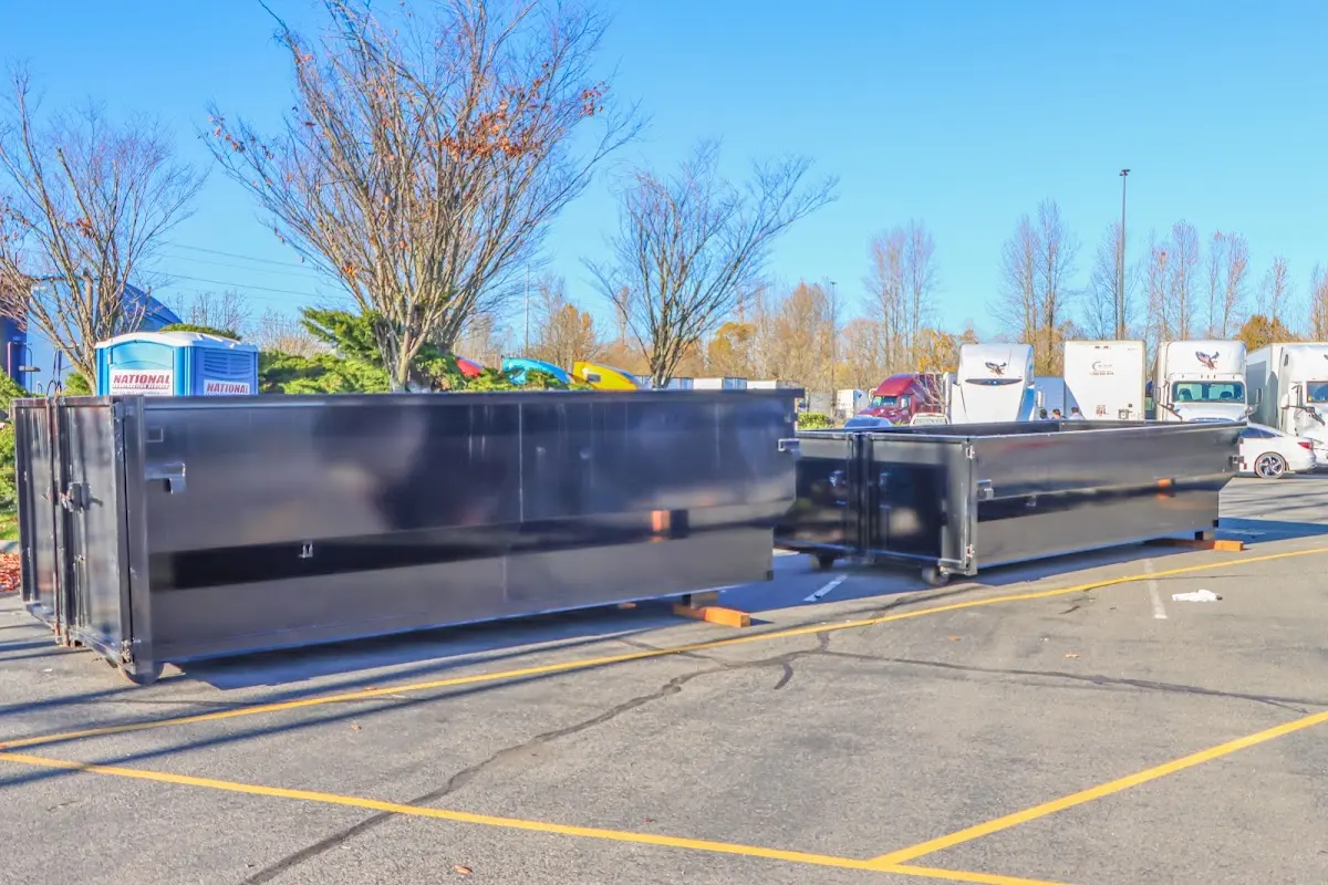 Professional dumpster rental service with roll-off container on residential driveway in Salmon Creek